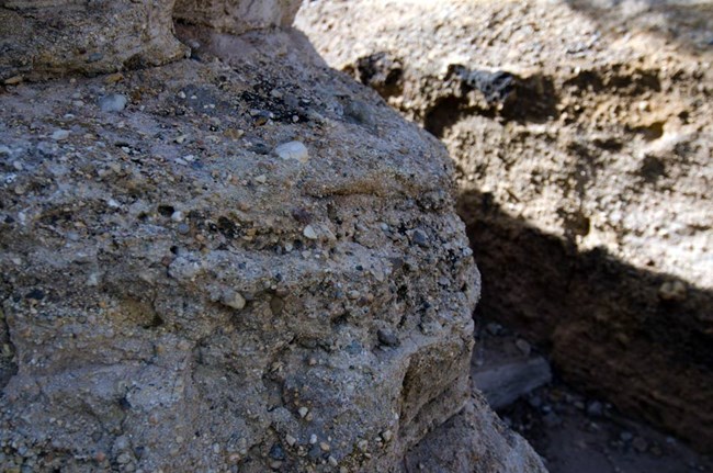 close-up of rock layers madeof hardened mud and river stones and pebbles