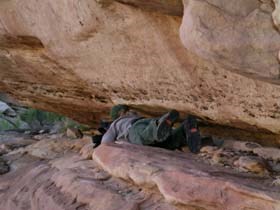 (sb) on rock ledge