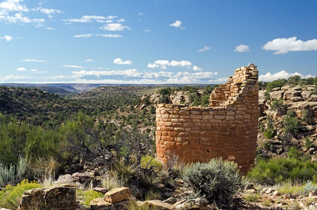 a small round stone tower perched on a canyon rim