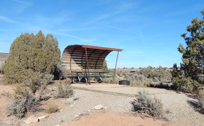a campsite with tent pad and covered shade structure a campsite with tent pad and covered shade structure
