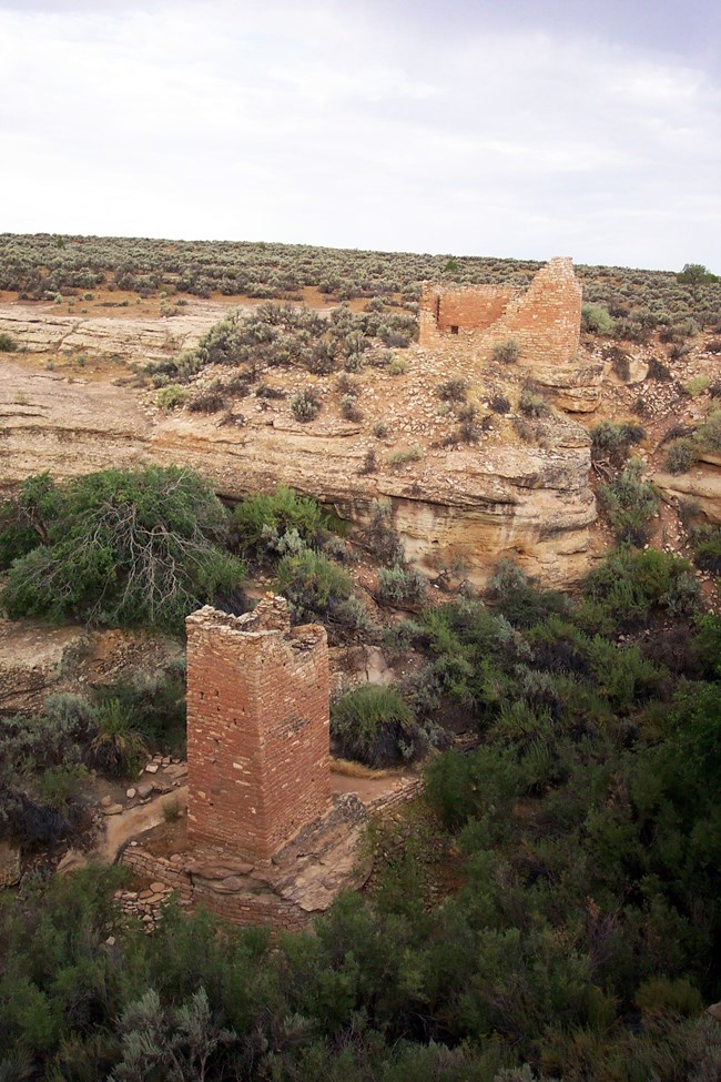 a tall, square stone tower at the head of a canyon