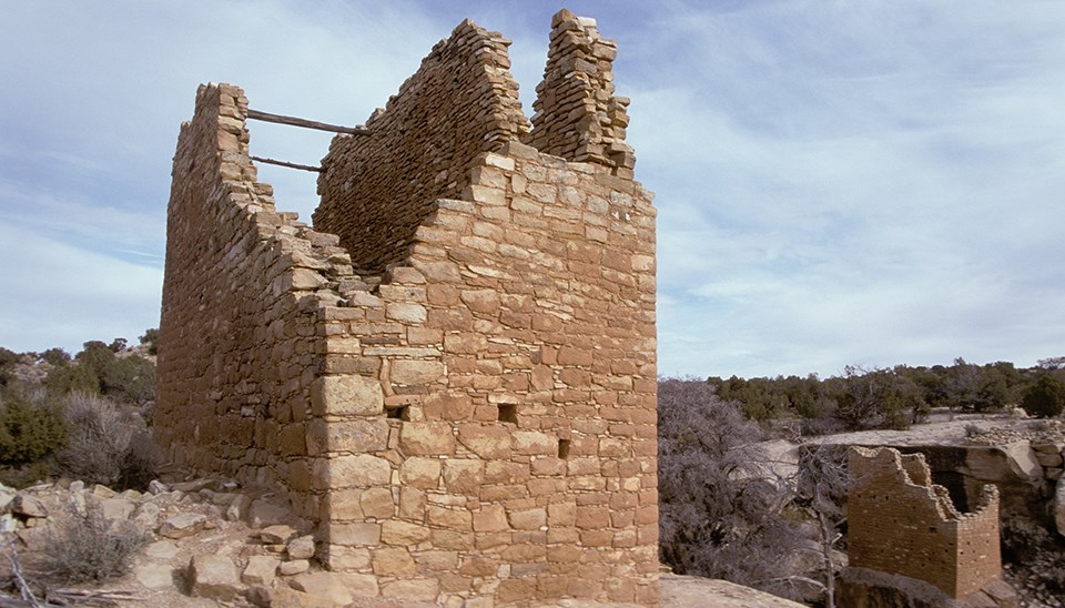 a stone tower with wood cross beams a stone tower with wood cross beams