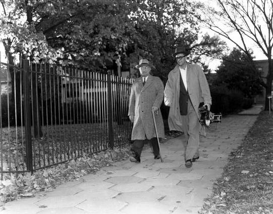 Truman walking with photographer in Independence.