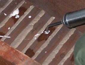 Adhesive is injected into drilled holes in the lath.