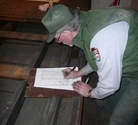 Staff member records board locations on chart.