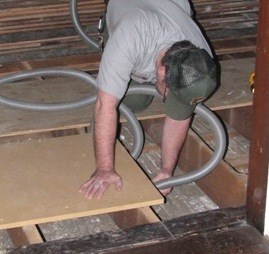 Floor cavity is vacuumed to remove debris.