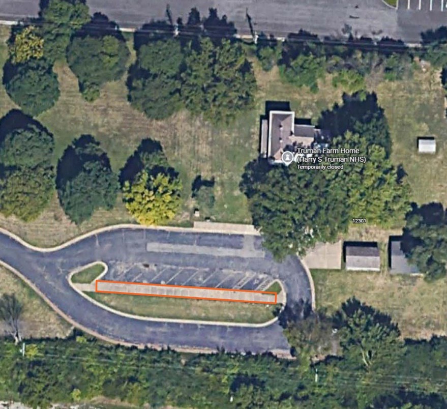 Aerial photogarph of the Truman farm home with designated demonstration area outlined in orange on the south parking lot sidewalk.
