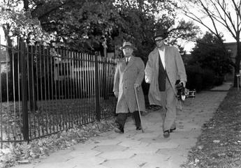 President Truman walking aside his home