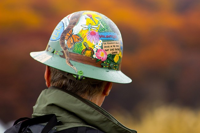 A Trail Volunteer wears a hard hat A Trail Volunteer wears a hard hat