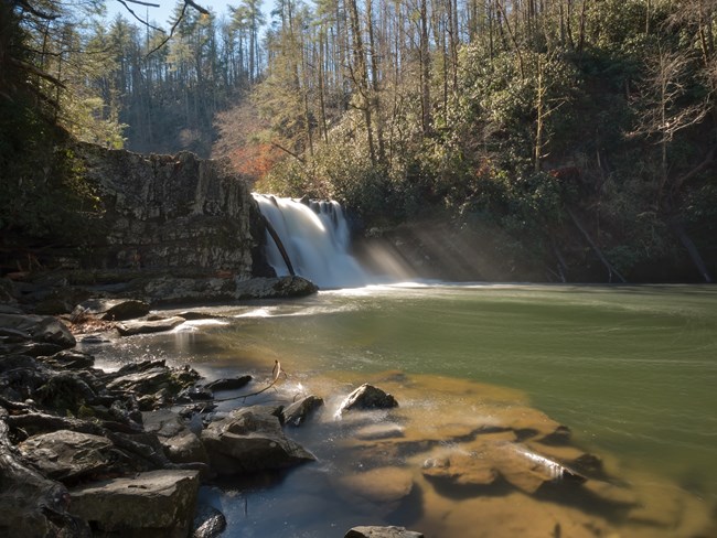 Abrams Falls in January 2017. Waterfall leads into a pool with rocks on the side.