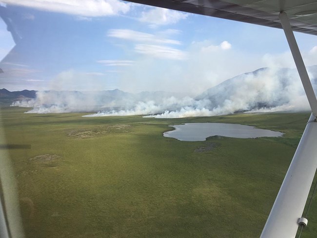 A view of a tundra fire from the window of an airplane.