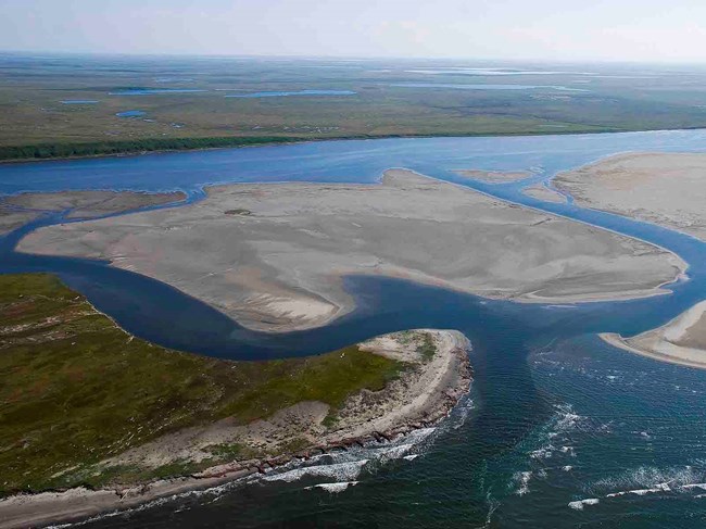 An aerial view of sandy barrier islands and coastal lagoons common in Arctic coastal parks.