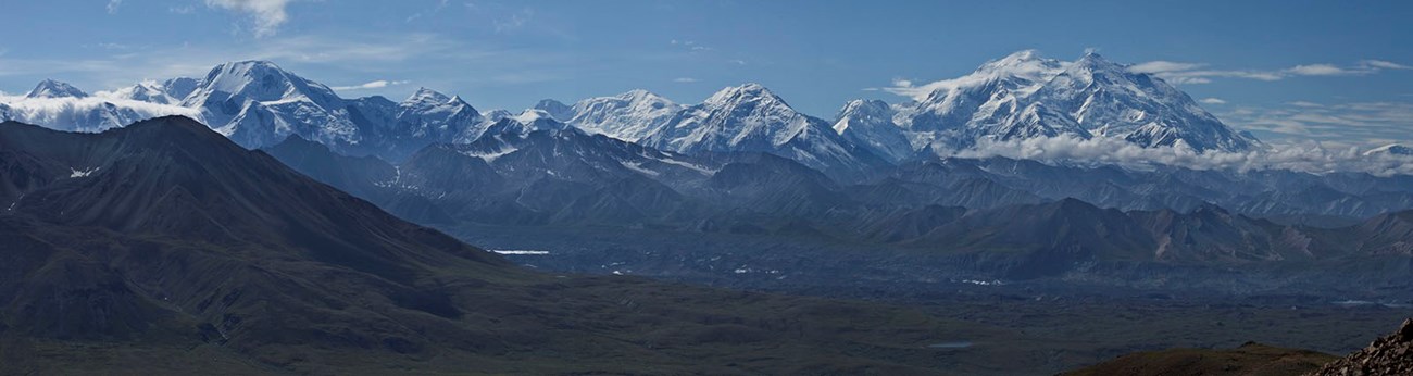 The Alaska Range, including Denali, is a long mountain range surrounded by boreal forest and tundra.
