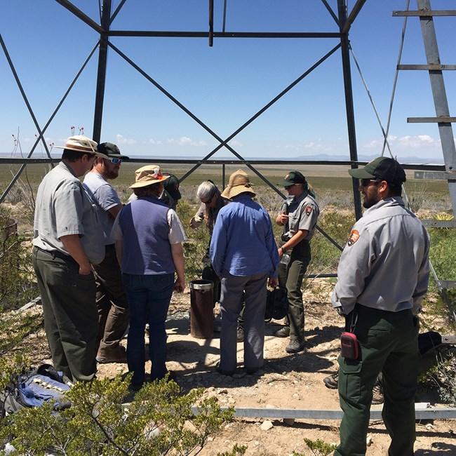 Groundwater monitoring at a well National Park Service staff and volunteers monitoring water at a well