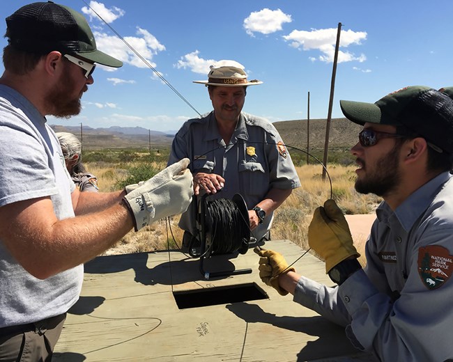 National Park Service staff measuring groundwater level at a well
