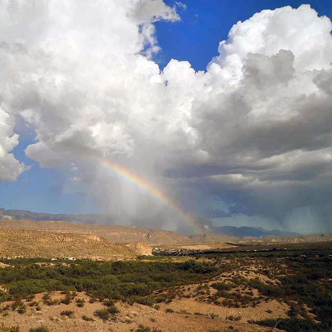 Desert storm with a rainbow