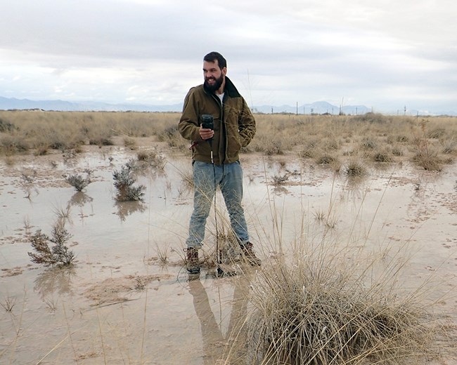 springs_WHSA_springs_monitoring_20141204_cropped_fixed Scientist taking water measurements at a spring