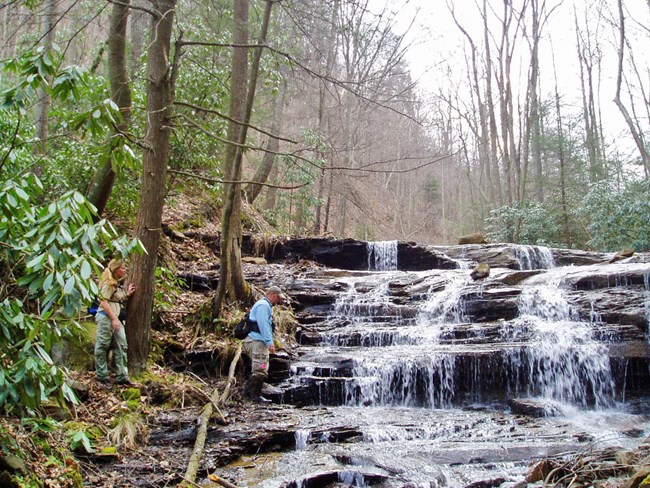 Bird monitoring at Slater Creek Two people along a cascading section of creek