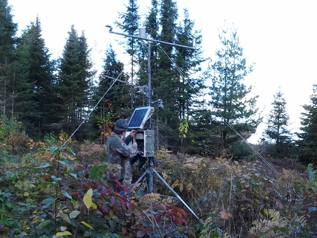 remote weather station Scientist checks instruments at a remote weather station