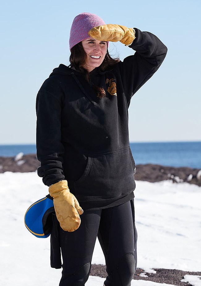 JaimeLeDuc a woman standing on snow holds her hand up to shade her eyes