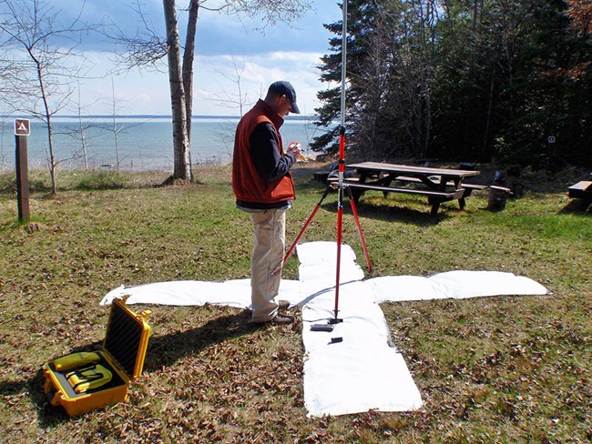 Aerial photo map target Person setting up a large white "X" on the ground