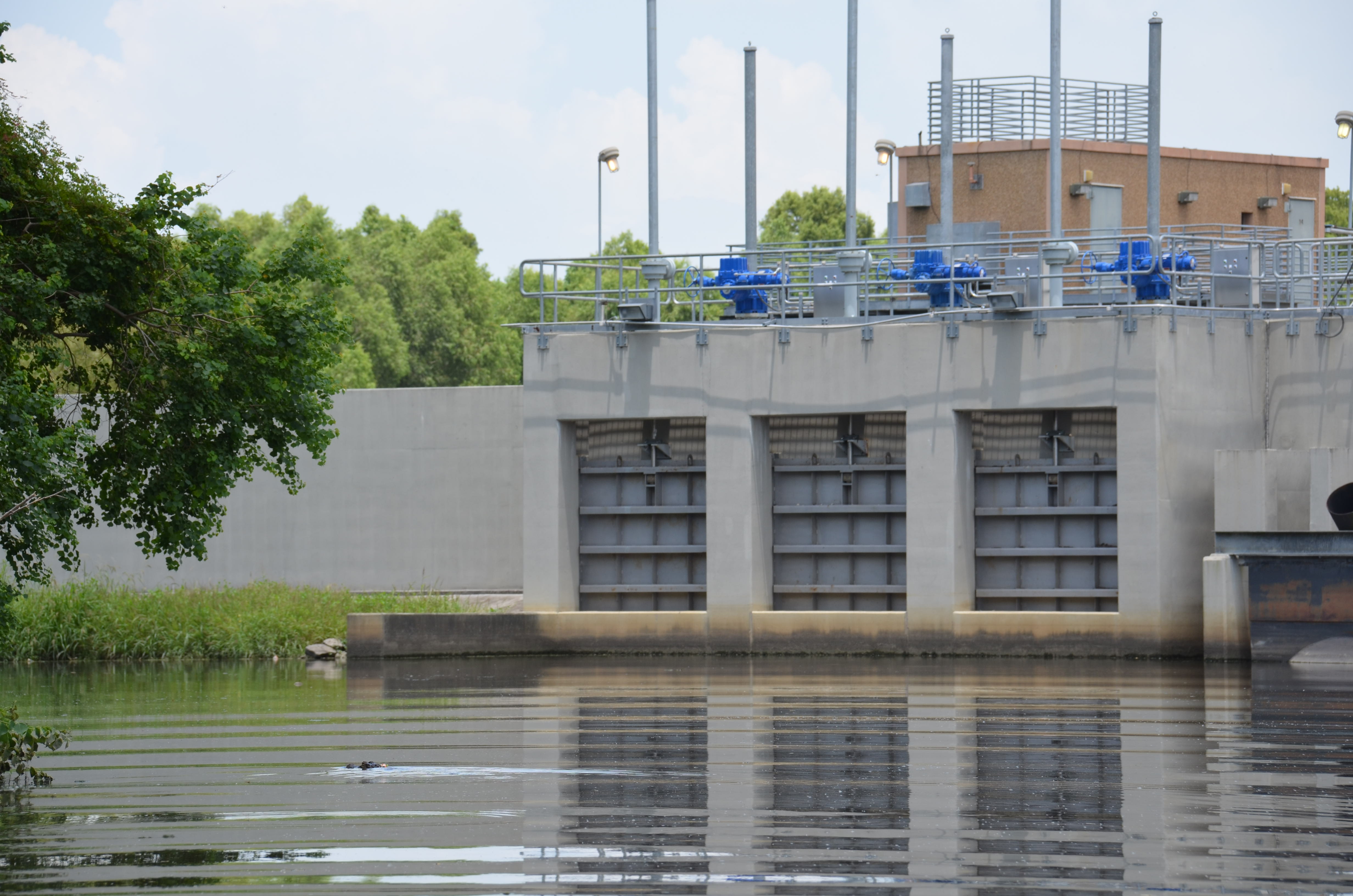 a canal next to a large concrete pump station