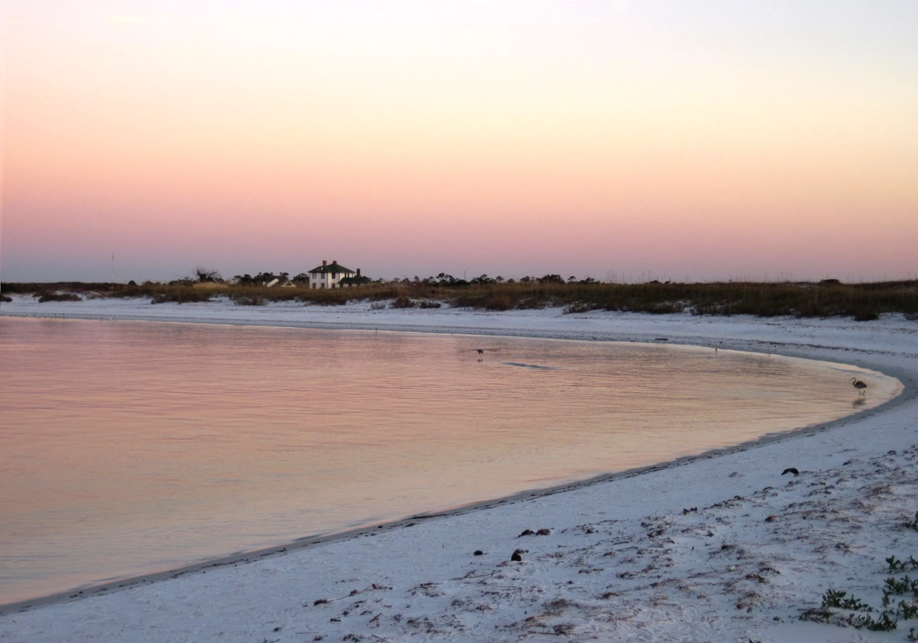 Shoreline at Gulf Islands National Seashore, Florida a curving shoreline on a calm, sandy beach at sunset
