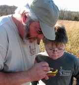 Mike DeBacker showing youth how to use field equipment