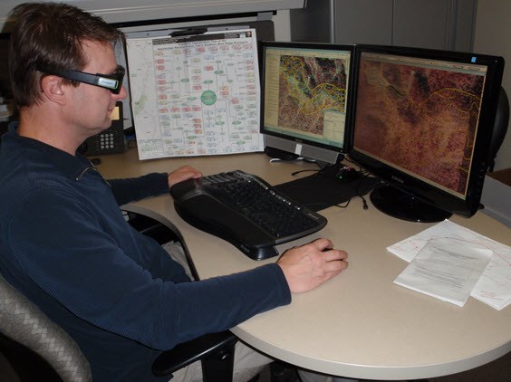 3-D tools for vegetation mapping Technician in front of computer monitors using 3-D glasses to view maps