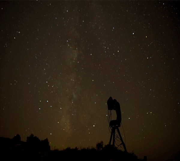 Timelapse of a night sky camera at work Timelapse of a camera turning on a large, automated mount as the stars move across the sky