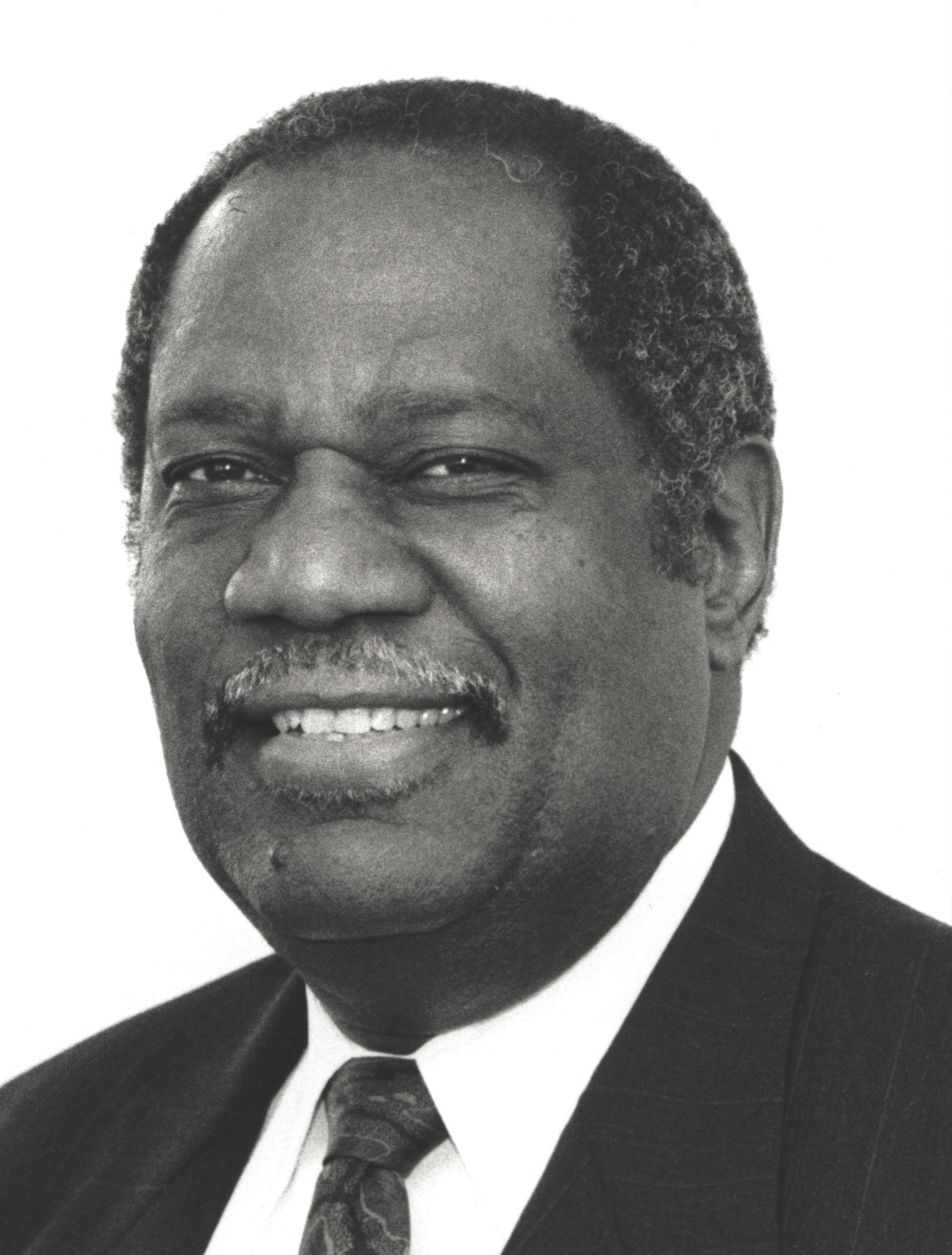Head shot of smiling Black man in suit and tie. Head shot of smiling Black man in suit and tie.