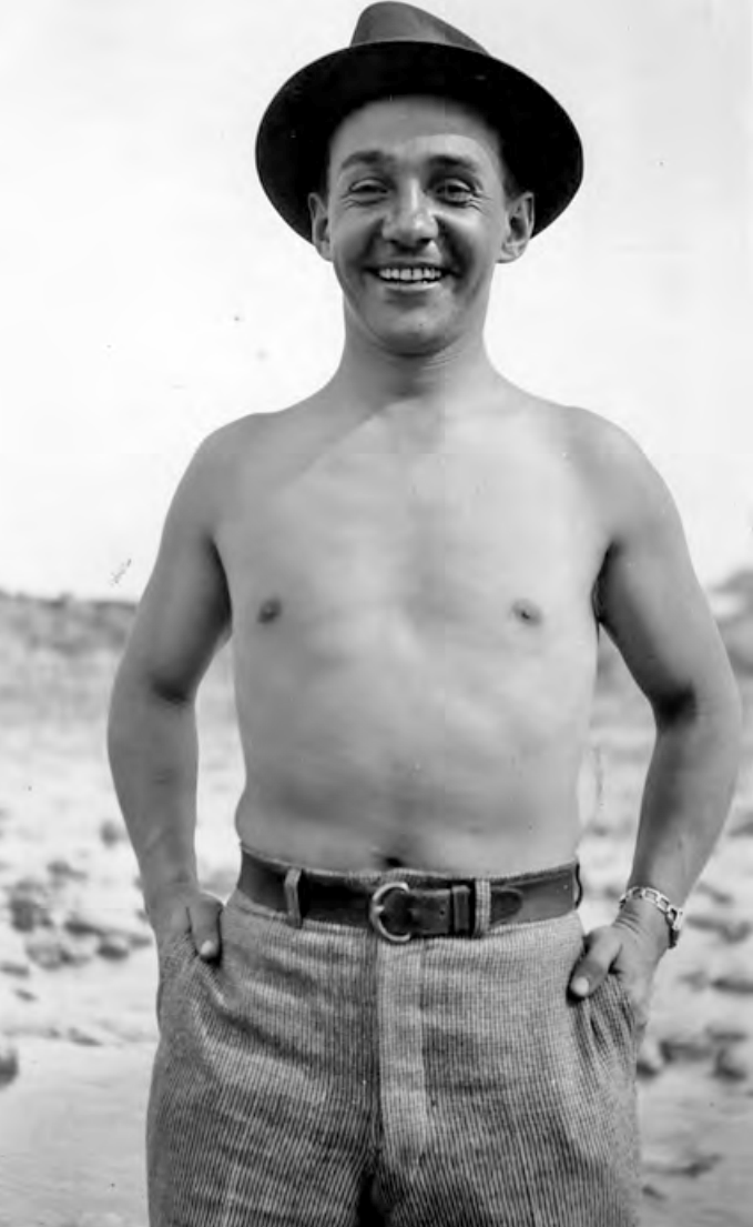 Smiling man, shirtless, wearing hat