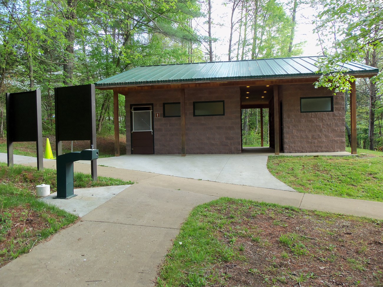 Comfort Stations 1 005 A small public building in a wooded area.