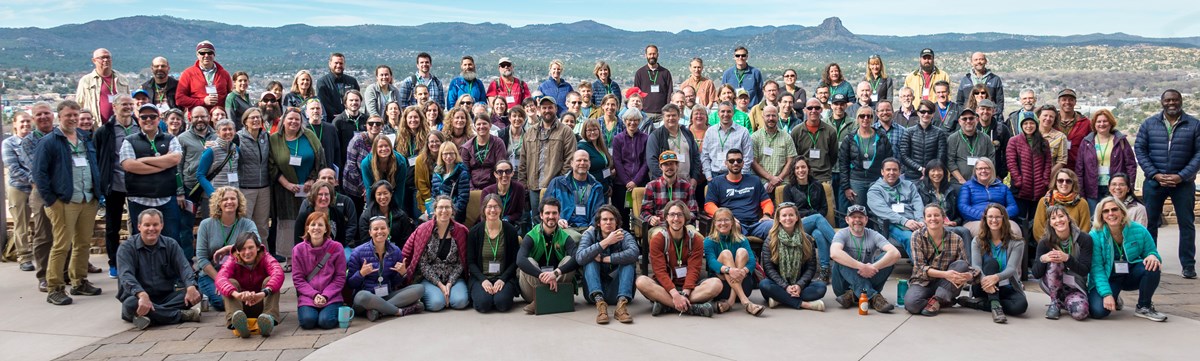 120+ Inventory & Monitoring staff gathered outside for a group photo.