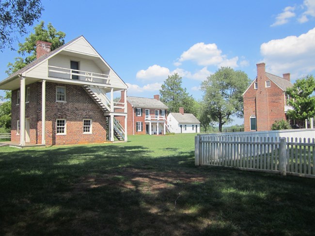 Cluster of historic buildings, including, from right to left, Clover Hill Tavern, and the tavern's slave quarters, kitchen, and guesthouse