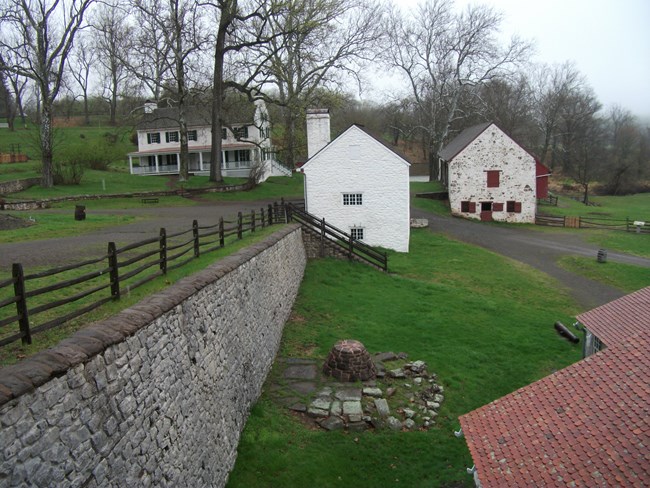 Cluster of white buildings connected by gravel paths and roads