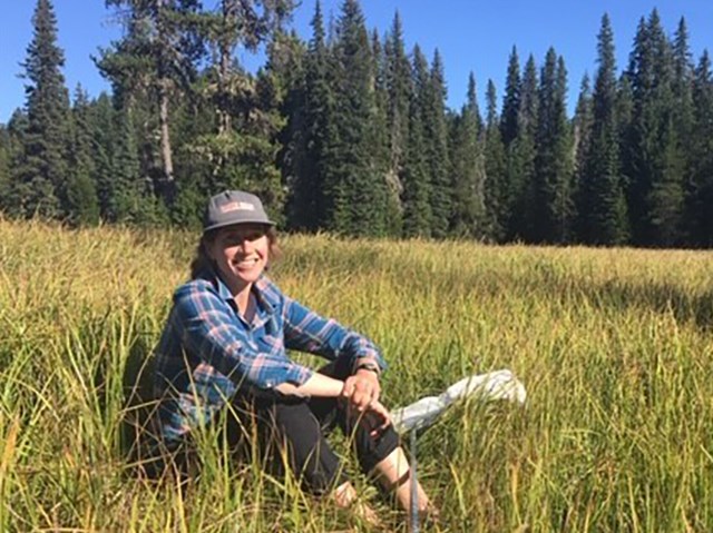 Marisa Monroe, Physical Science Technician Woman seated in tall grass wearing wide-brimmed hat