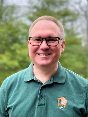 Dennis Skidds, NCBN Data Manager Portrait of Dennis wearing a light green polo shirt with NPS arrowhead