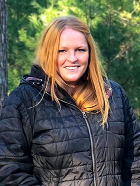 Robin Baranowski, Biological Science Technician Robin wearing a black jacket in a forested area