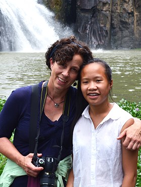 Sara Stevens, Network Program Manager Sara with her daughter standing in front of a waterfall