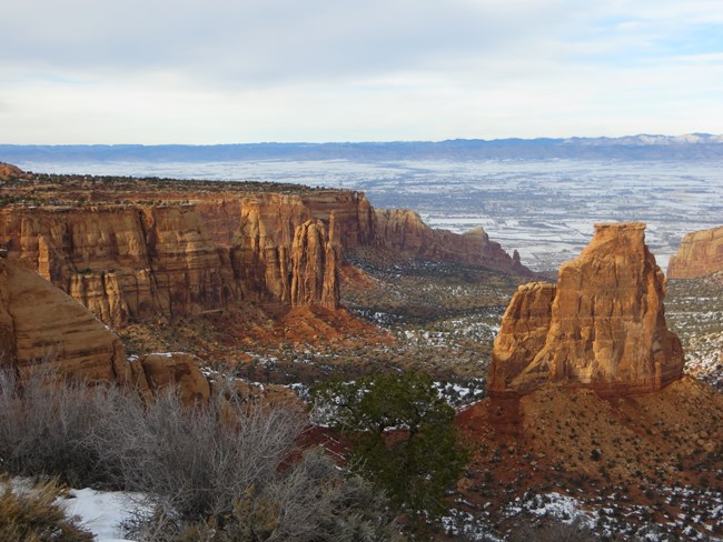 Red rock canyons with open, flat landscape beyond Red rock canyons with open, flat landscape beyond