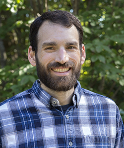 Smiling bearded man in blue plaid shirt