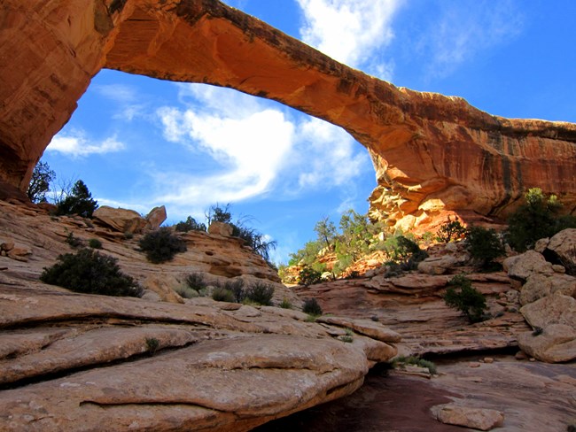Red rock arch against brilliant blue sky