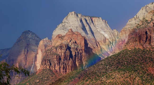 Rainbow below towering rock landscape