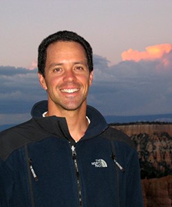 Man in front of canyon sunset