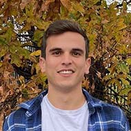 Portrait of smiling man in front of autumn tree