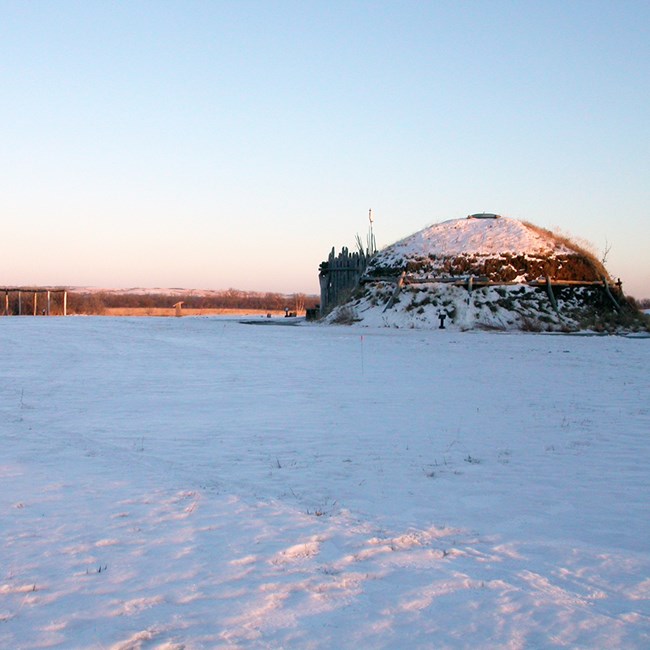 Historic Native American structure blanketed in snow