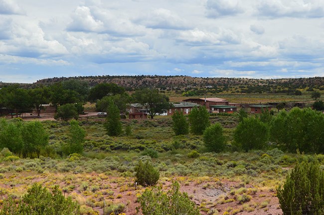 Hubbell Trading Post National Historic Site Hubbell Trading Post buildings in a mostly shrubby landscape dotted with trees