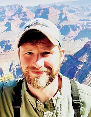 SCPN Avian Ecologist Harrison Jones Bearded man with cap in Grand Canyon