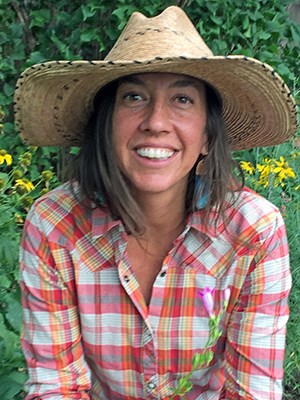 Smiling woman in straw hat.